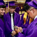 Friends check out selfies before the graduation ceremony begins.